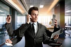 Ufficio comunale con personale al lavoro e documenti di sicurezza sulla scrivania.